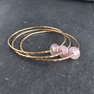 Yay Hawaii rose quartz rondelle gemstone bangle featuring polished pink gemstones on a sleek bracelet design