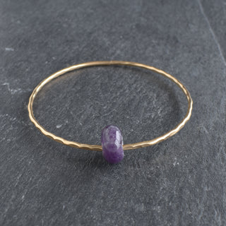 Amethyst rondelle gemstone bangle by Yay Hawaii featuring polished purple beads on a flexible jewelry band.