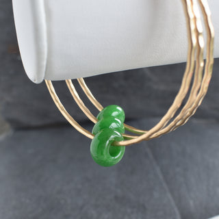 Yay Hawaii jade rondelle gemstone bangle featuring polished green jade beads on a flexible bracelet for stylish wear.
