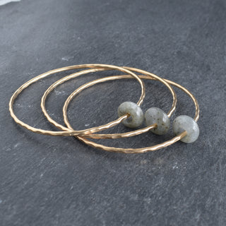 Blue Flash Labradorite gemstone bangle with round rondelle beads, showcasing iridescent blue flash and natural gemstone texture.