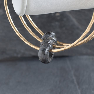 Larvikite gemstone bangle with round rondelle beads, handcrafted jewelry from Yay Hawaii featuring polished dark, iridescent stones.