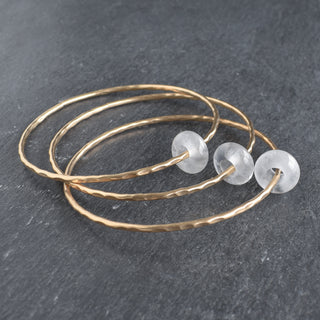 Clear Quartz Rondelle Gemstone Bangle from Yay Hawaii, featuring polished round quartz beads on a flexible bracelet.