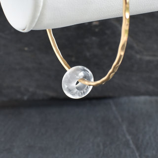Clear Quartz Rondelle gemstone bangle featuring polished, rounded quartz beads on a flexible jewelry band.