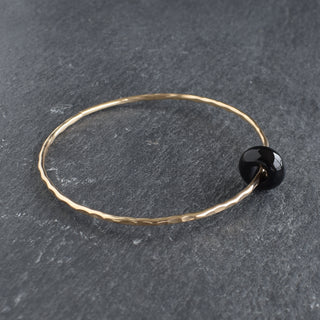 Black Agate Rondelle Gemstone Bangle featuring smooth black agate beads strung together in a stylish bracelet design.