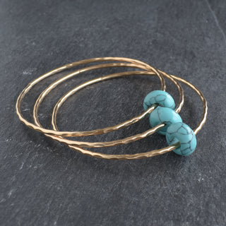 Turquoise rondelle gemstone bangle by Yay Hawaii featuring polished turquoise beads on a flexible jewelry band