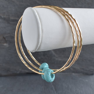 Turquoise gemstone bangle with round rondelle beads, handcrafted jewelry by Yay Hawaii, showcasing vibrant turquoise stones and silver accents.