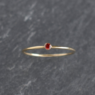Dark red cubic zirconia stacking ring with garnet January birthstone, designed by Yay Hawaii, featuring a sleek gold band.