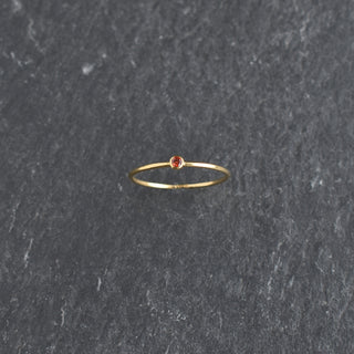 Red cubic zirconia stacking ring with ruby July birthstone by Yay Hawaii, featuring a sleek band and vibrant gemstone.