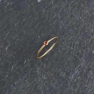 Red cubic zirconia stacking ring by Yay Hawaii featuring a Ruby July birthstone, with a sleek gold band design.