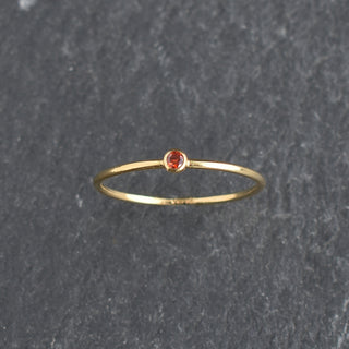 Red cubic zirconia stacking ring with ruby July birthstone by Yay Hawaii, featuring a sleek band and sparkling gemstone.