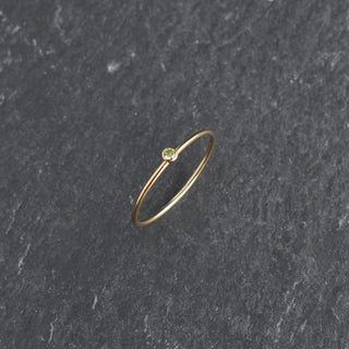 Light green CZ stacking ring with peridot birthstone from Yay Hawaii, showcasing a delicate band and sparkling gemstone.