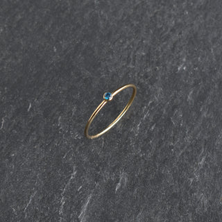 Blue CZ stacking ring featuring a sapphire birthstone from Yay Hawaii, showcasing a delicate, layered gold band design.
