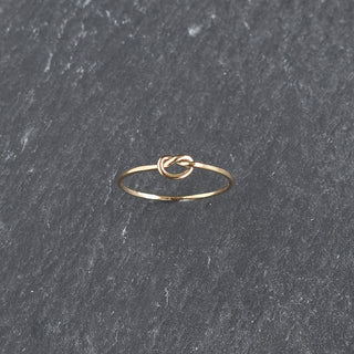 Yay Hawaii knotted stacking ring made of silver with intertwined knot design, displayed on a white background.