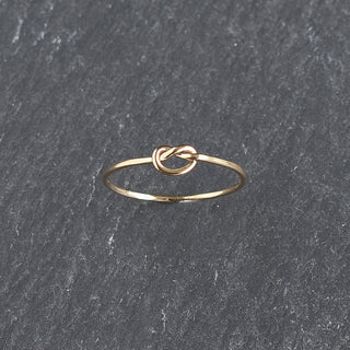 Stacked knotted rings from Yay Hawaii, featuring minimalist gold band design with intertwined knot accents.