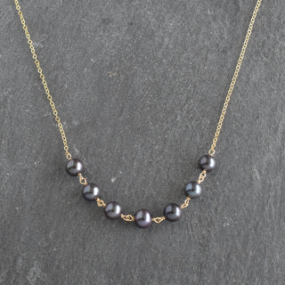 Yay Hawaii statement necklace with seven linked 8mm black freshwater pearls on a delicate chain.
