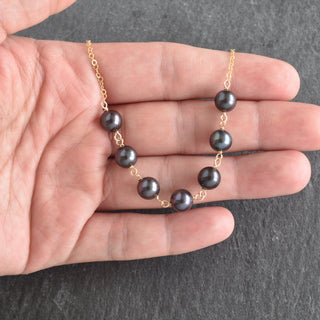 Yay Hawaii statement necklace with seven linked 8mm black freshwater pearls, elegant jewelry piece for sophisticated style.