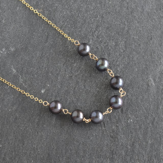 Yay Hawaii statement necklace with seven linked 8mm black freshwater pearls on a delicate chain.