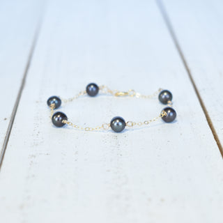 Dainty black freshwater pearl station bracelet featuring 8mm pearls, crafted by Yay Hawaii, on a delicate jewelry chain.