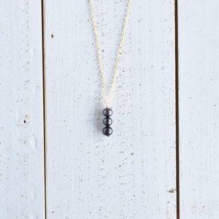 Yay Hawaii black freshwater pearl vertical pendant necklace with 8mm pearls, elegant jewelry accessory.