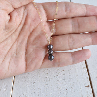 Black freshwater pearl pendant necklace with vertical design by Yay Hawaii, featuring three 8mm pearls on a sleek chain.