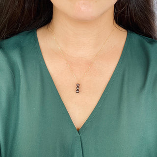 Yay Hawaii black freshwater pearl vertical pendant necklace with 8mm pearls on a delicate chain, showcasing elegant jewelry design.